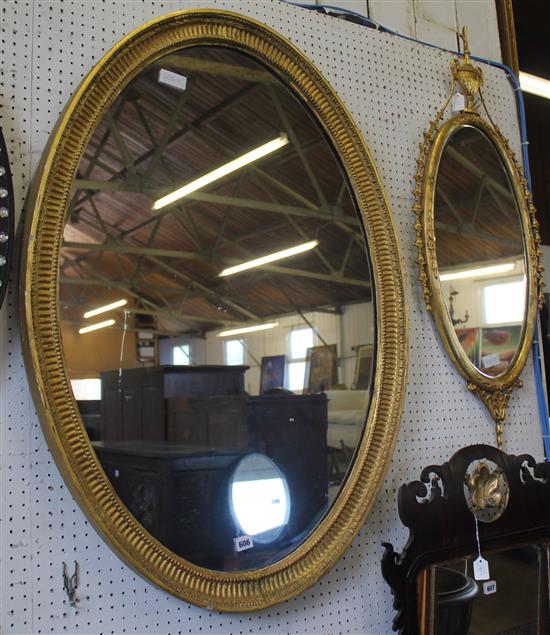 Oval gilt wall mirror and another urn finial